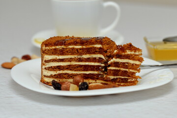 honey cake on a plate with nuts and tea for dessert