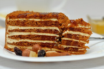 honey cake on a plate with nuts and tea for dessert