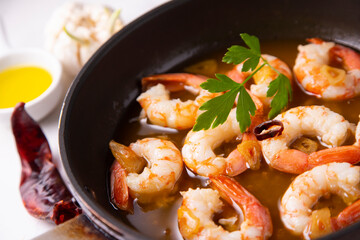 Gambas al ajillo. Shrimp Scampi. Traditional Spanish tapa with prawns cooked in oil with garlic and...