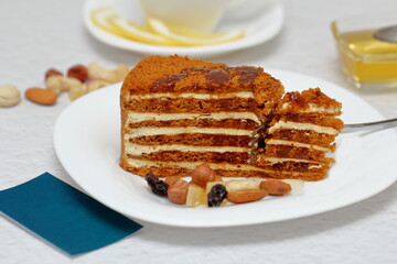 honey cake on a plate with nuts and tea for dessert