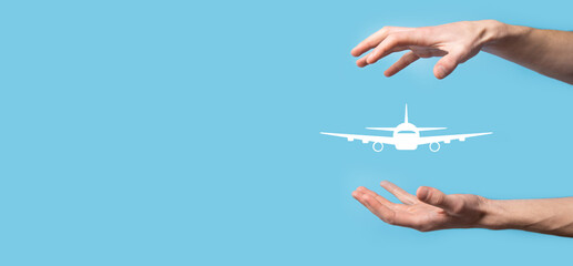 Male hand holding plane airplane icon on blue background. Banner.nline ticket purchase.Travel icons...