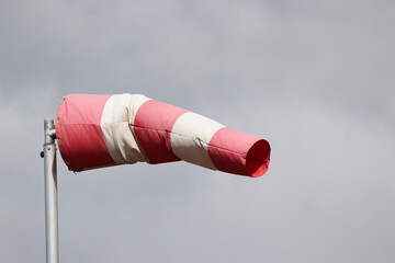 red and white windsock to indicate direction and strength of the wind