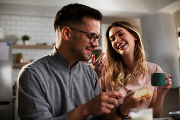 Husband and wife enjoying in breakfast. Loving couple drinking coffee in the kitchen.