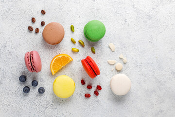 Various macaroons with pistachios,fruits,berries,coffee beans.