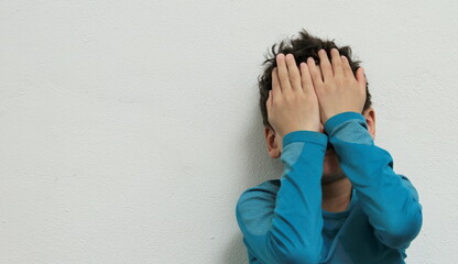 boy crying in poverty with no help crying alone and all by himself on white background  stock photo