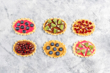 Fototapeta na wymiar Homemade desserts with blueberries,kiwi slices and pomegranate seeds.
