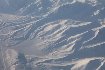 Aerial view of snowy mountains, top view of winter landscape