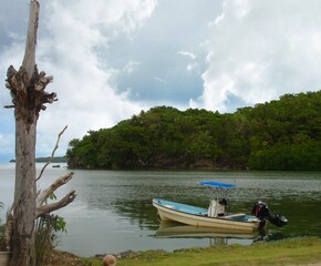 Naklejka na ściany i meble Motor boat docked in a small cove in Ngarchelong State, Palau.