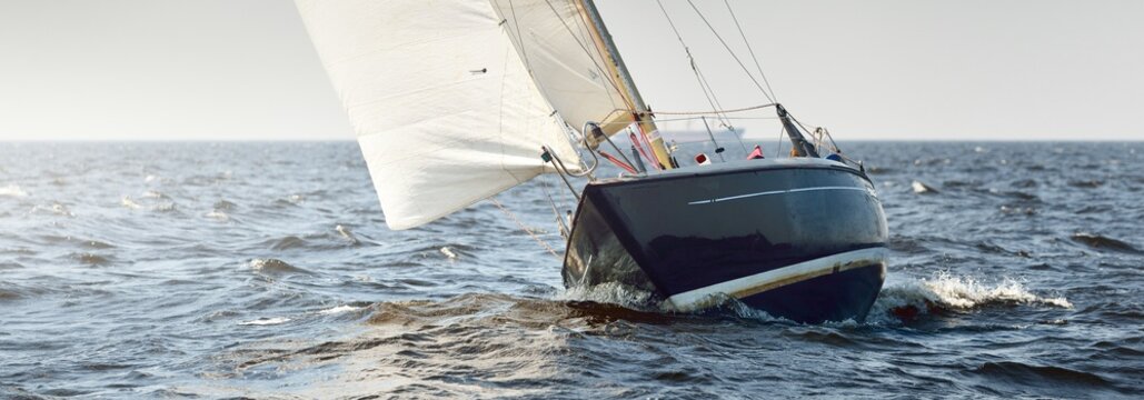 Heeled sloop rigged yacht sailing in an open Baltic sea on a clear day. Regatta, racing, sport, recreation, leisure activity, transportation, nautical vessel, adventure