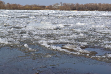 Spring landscape. View from the river bank on the ice drift.