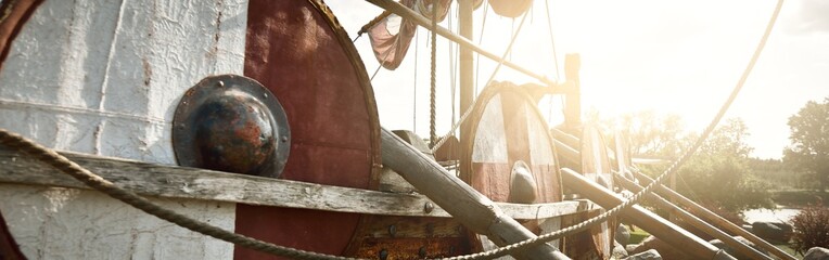 Old wooden viking snekkja longship type, close-up. Nautical vessel, tall ship, traditional craft, vintage, landmark, history, past, historical reenactment, nordic culture © Alex Stemmer