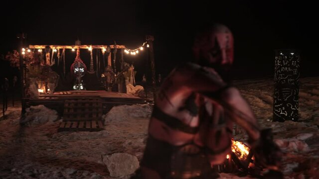 Battle an evil aggressive viking warrior in northern tattoos with a bare torso on burning fire swords with an opponent from our days wearing glasses