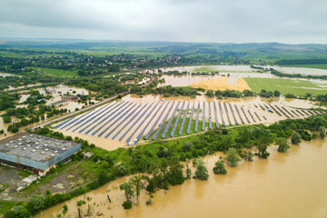 Fototapeta na wymiar Aerial view of flooded solar power station with dirty river water in rain season.