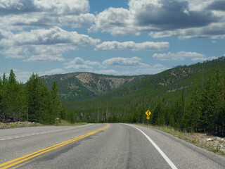 Paved road and landscape at Yellowstone National Park, Wyoming.