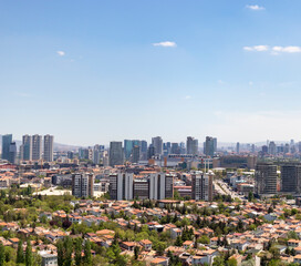 Fototapeta premium Ankara province, Cankaya district, there are villas in the foreground from high view, there are large modern buildings in the background.