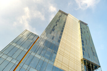 Fototapeta na wymiar Perspective view of modern high-rise glass skyscraper building.