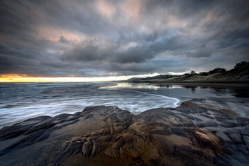 Obraz na płótnie Canvas Muriwai Beach Auckland New Zealand Dramatic Sunset