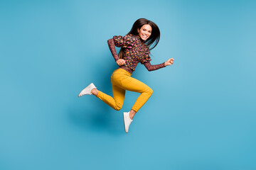 Fototapeta na wymiar Profile side full size photo of young cheerful attractive smiling woman running fast isolated on blue color background