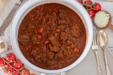 Overhead view of a pot with fresh cooked italian beef stew alla bolognese