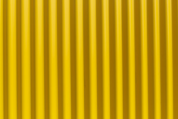 Bright yellow corrugated iron on a sidewalk - obrazy, fototapety, plakaty