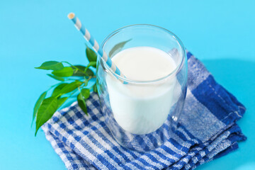 Glass of milk on a blue background. Milk products.