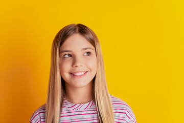 Photo of inspired kid girl think look copyspace over yellow background