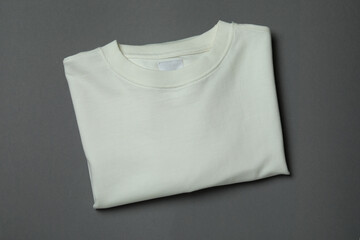 White sweatshirt on gray background, space for text