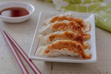 Fried dumplings Gyoza on plate and soy sauce.