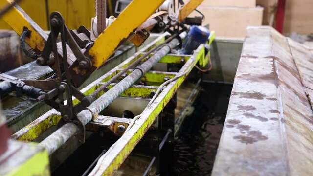 The process of immersing small parts in an electroplating bath. Barrels of metal rotate in an electroplating bath.
