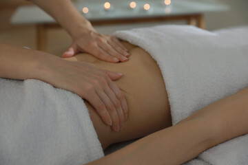 Obraz na płótnie Canvas Woman receiving professional belly massage in wellness center, closeup