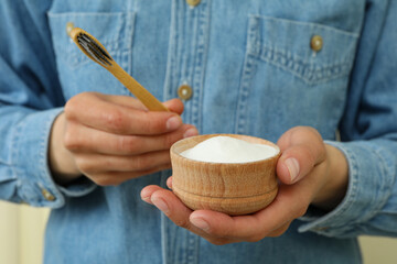 Woman hold tooth powder and toothbrush, close up
