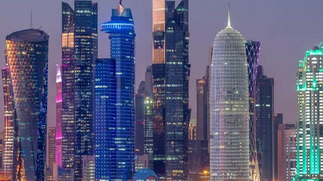 Skyline with Skyscrapers day to night timelapse in Kuwait City downtown illuminated at dusk. Kuwait City, Middle East