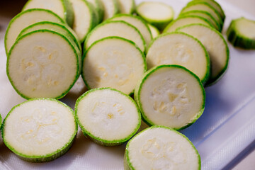 Cut zuccinis on white cutting board