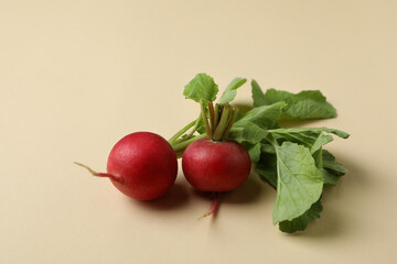 Fresh radish on beige background, close up