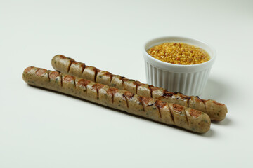 Grilled sausage and sauce on white background