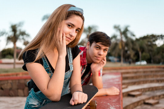 Portrait of an adorable teenage couple in an urban park.