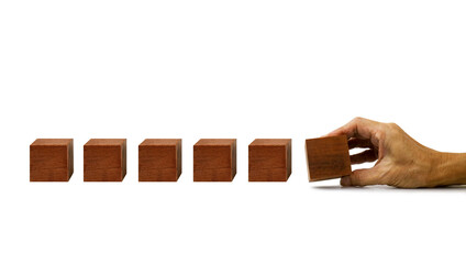The hand establishes a blank (waiting for your text ) wooden cube in row on a white background  ,Cube block in hand