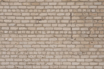 An old brick wall darkened by time with traces of destruction. High quality photo