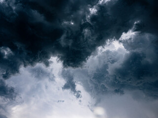 Naklejka na ściany i meble Dramatic dark grey clouds sky with storm and rain.