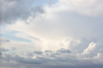 Part of anvil shaped mushroom form cumulonimbus storm and rain cloud with smaller cumulus clouds...