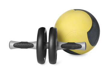 Medicine ball and abdominal wheel on white background