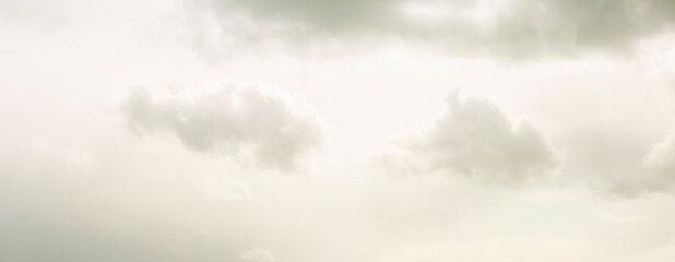 Obraz premium Moody panorama of fluffy cumulus clouds gently drifting through cloud filled frame. Climate and weather concept. Detail natural phenomenon.