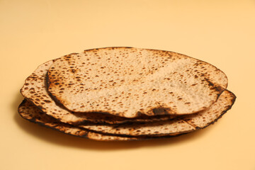 Tasty matzos on beige background. Passover (Pesach) celebration
