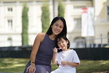 asian chinese child and mother enjoying the moment after tasting ice cream