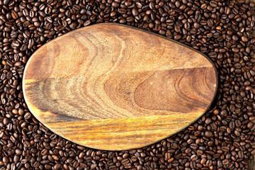 Wooden board on coffee beans. Signboard for a coffee shop or cafe. Copy space