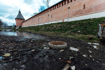 an old dried-up pond in mud and garbage. an abandoned park near the old fortress. desolation in the...