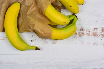 Group of bananas on white rustic table. Copy space.