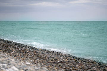 Fototapeta na wymiar The surf with a pebble beach on the Black Sea