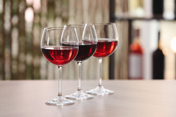 Different sorts of wine in glasses on table indoors - obrazy, fototapety, plakaty