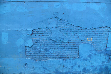 Old Brick wall painted with blue paint.